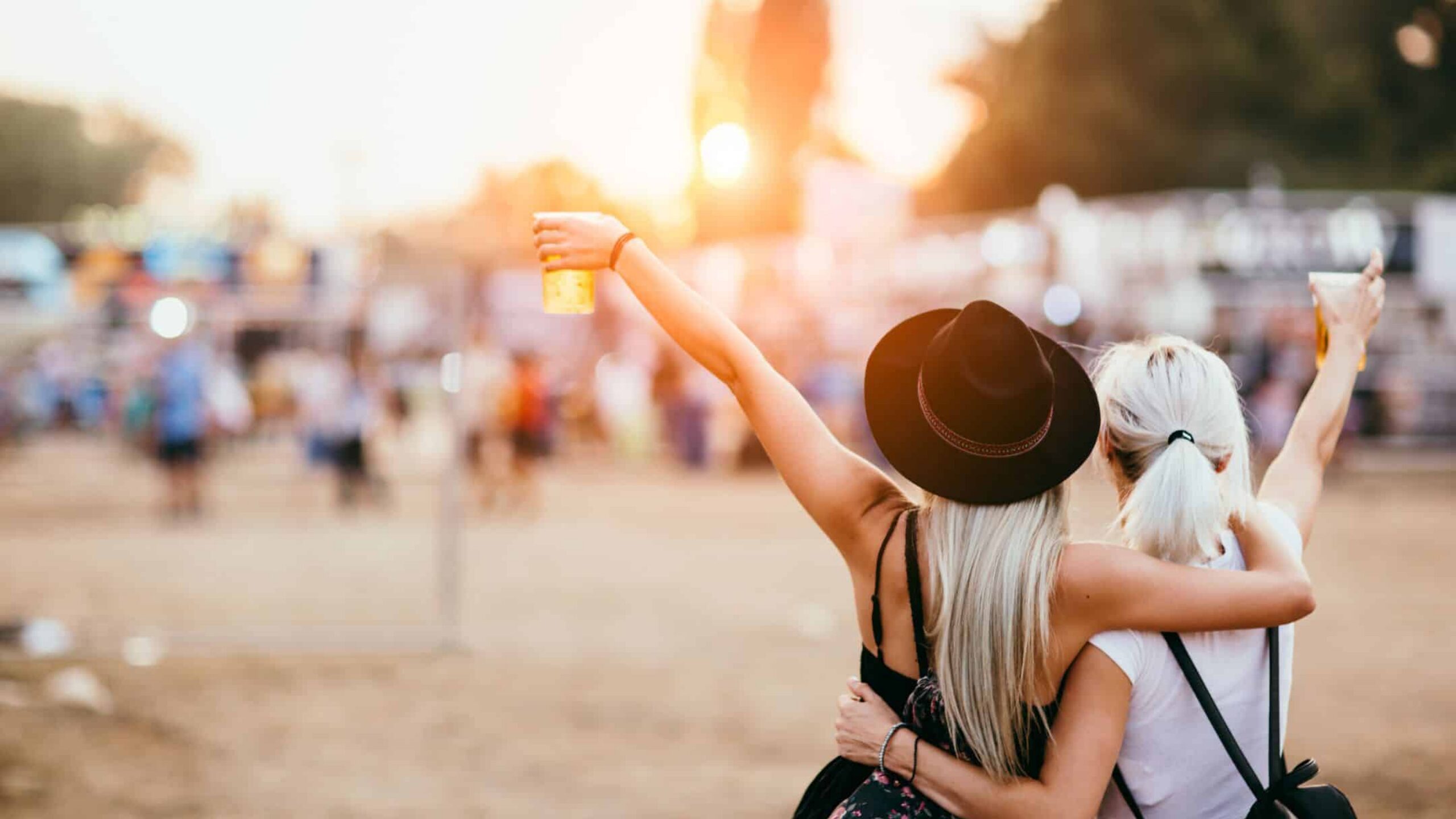 Festival-goers celebrating at Glastonbury, near The Pop-Up Camp