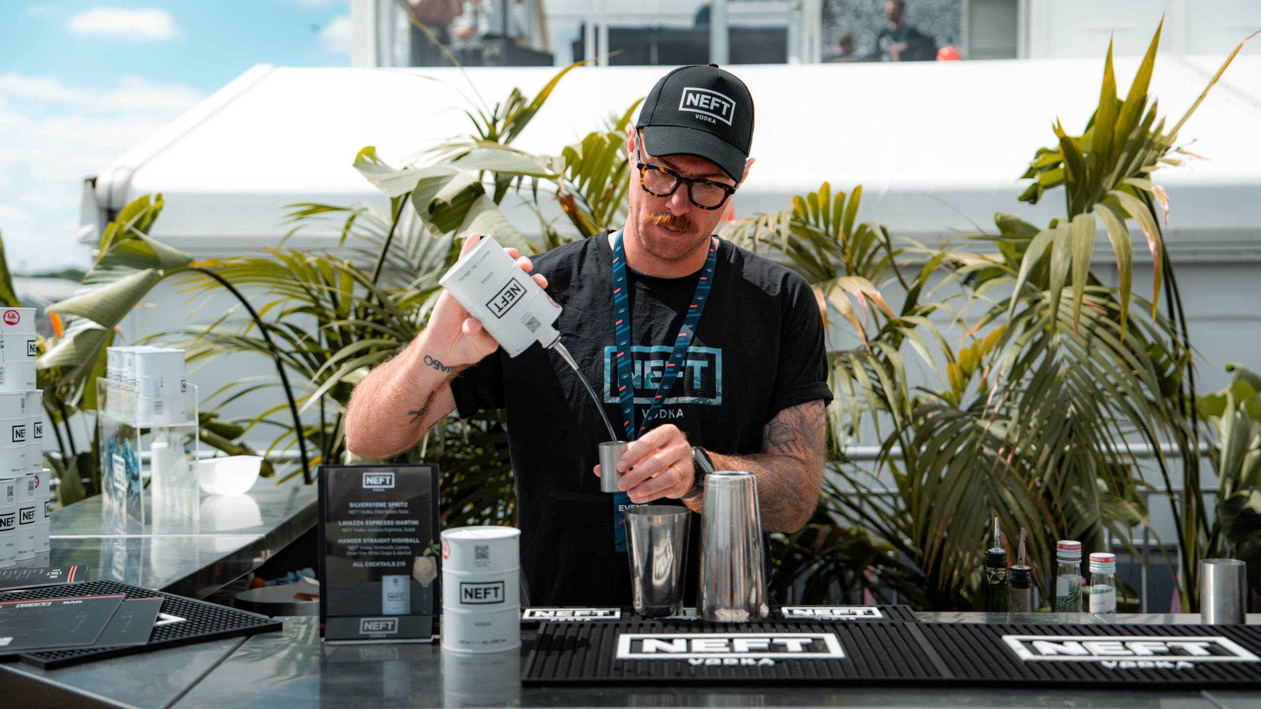 A bartender mixing a cocktail at the outdoor bar