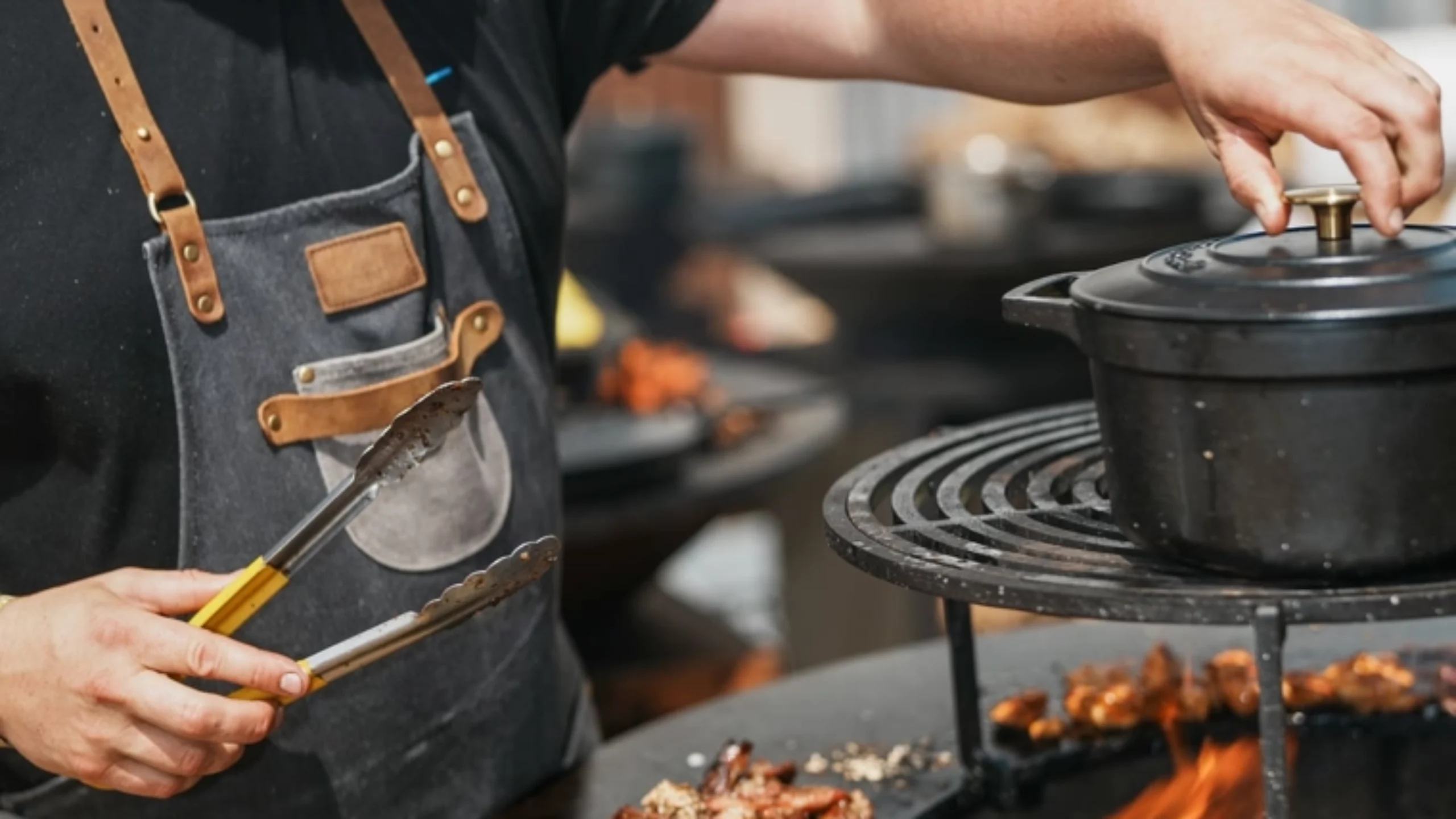 A chef cooking over the stove in the open kitchen
