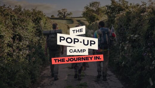 Festivalgoers with rucksacks walking down a country lane with The Pop-Up Camp logo and the line The journey in