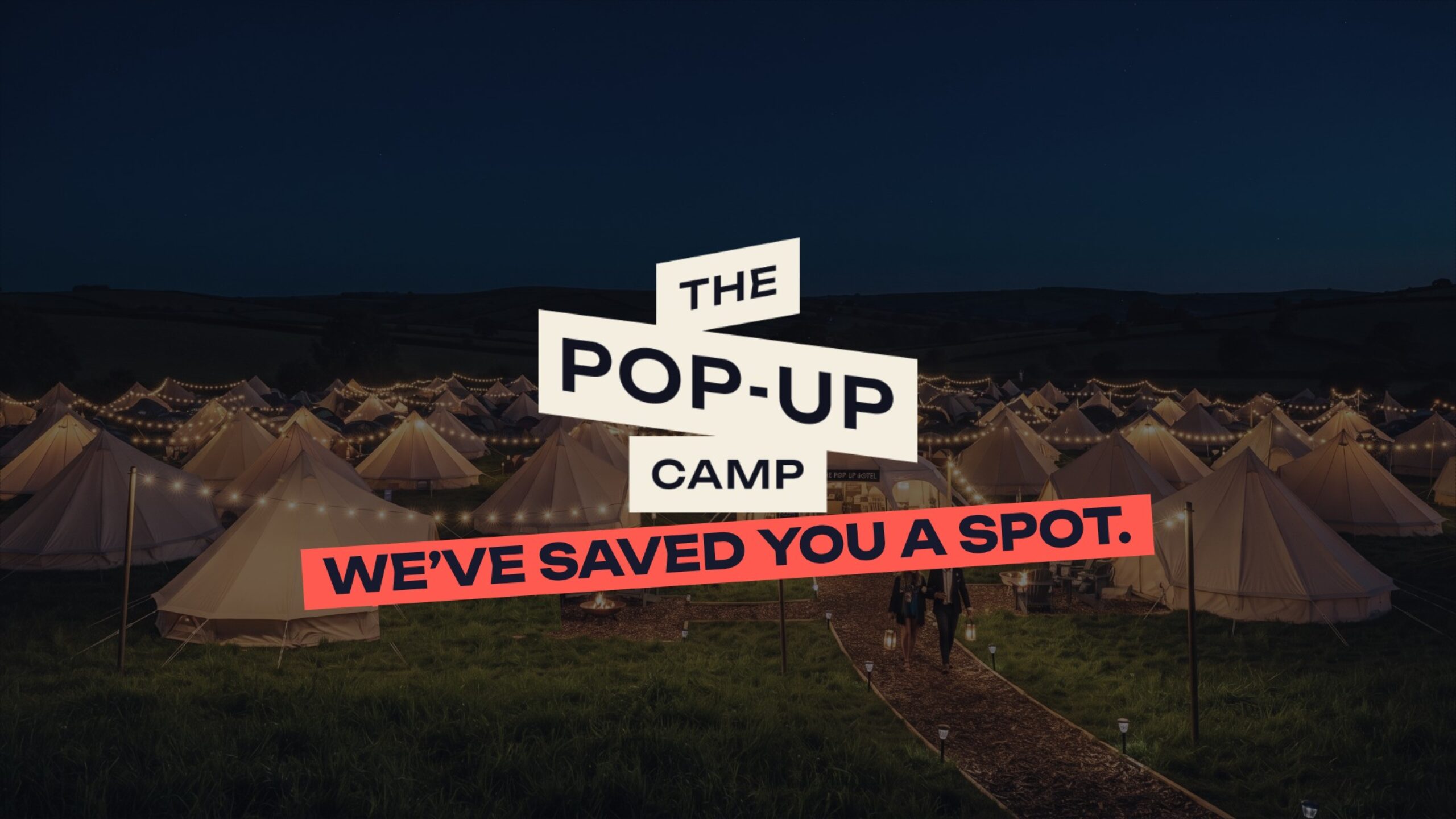 Bell tents lit with festoon lights at night with The Pop-Up Camp logo and the line We've saved you a spot